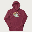 Maroon hoodie with a retro-inspired graphic of a mushroom mascot character and the text 'Let's Get Fungi'.