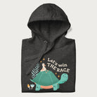 Folded dark grey hoodie with a graphic of a turtle with a duck on its back and the text 'Let's Win the Race'.