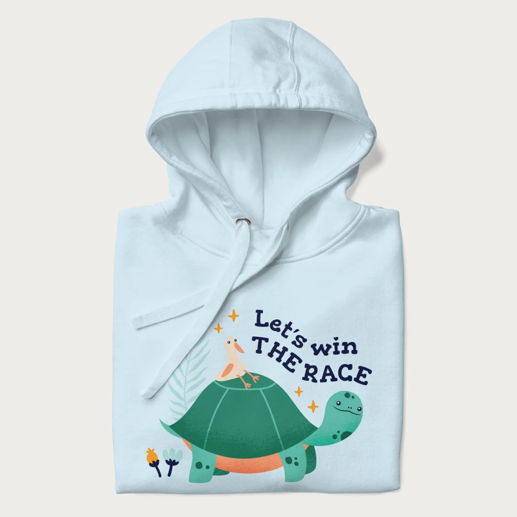 Folded light blue hoodie with a graphic of a turtle with a duck on its back and the text 'Let's Win the Race'.