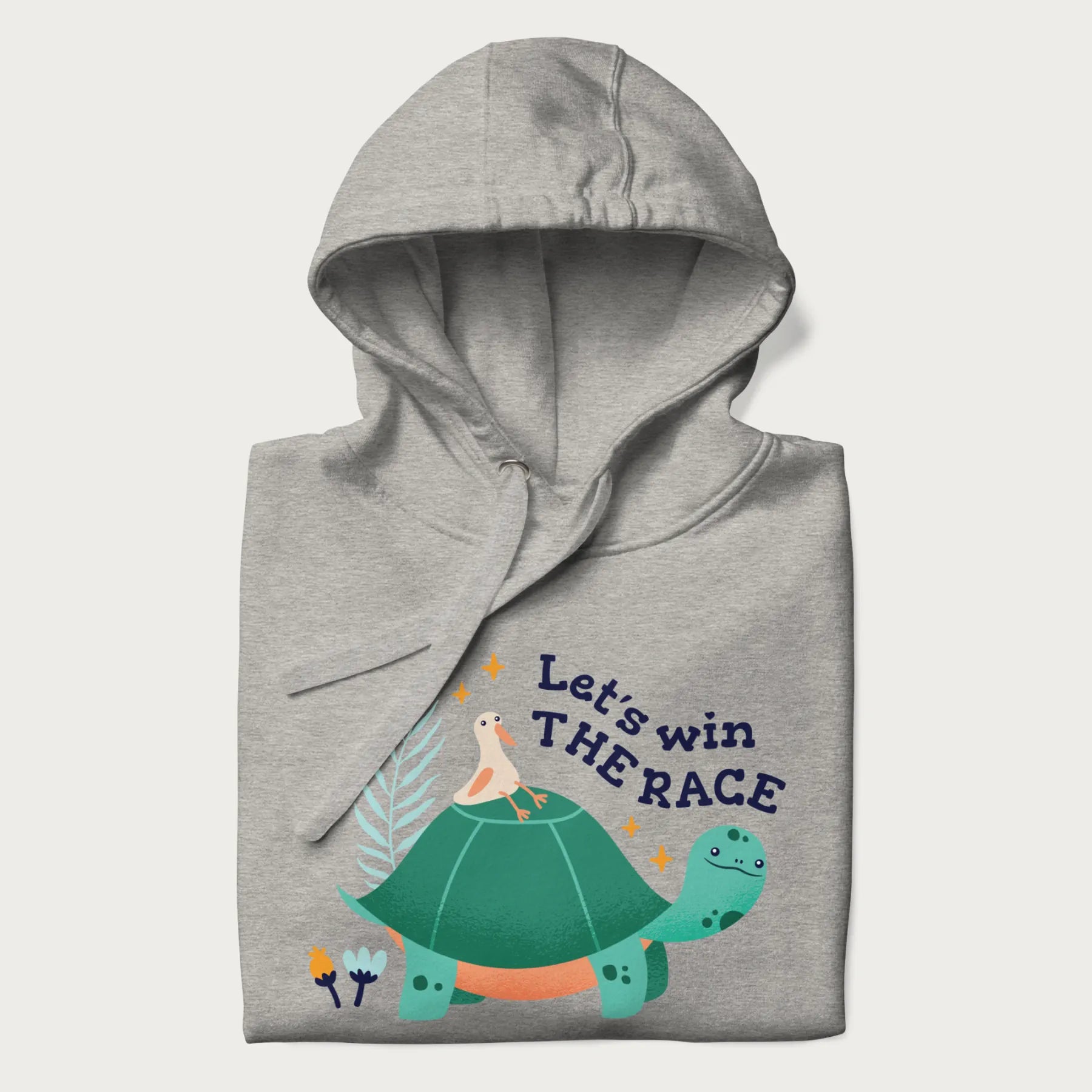 Folded light grey hoodie with a graphic of a turtle with a duck on its back and the text 'Let's Win the Race'.