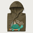 Folded military green hoodie with a graphic of a turtle with a duck on its back and the text 'Let's Win the Race'.