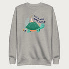 Light grey sweatshirt with a graphic of a turtle with a bird on it's shell with the phrase 'Let's Win the Race.'