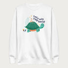 White sweatshirt with a graphic of a turtle with a bird on it's shell with the phrase 'Let's Win the Race.'