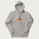 Light grey hoodie with graphic of a dapper frog reading a book on a mushroom with the text 'Don't Be Stressing, Life's a Blessing' above and below.