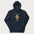 Navy blue hoodie with graphic of a dapper frog reading a book on a mushroom with the text 'Don't Be Stressing, Life's a Blessing' above and below.