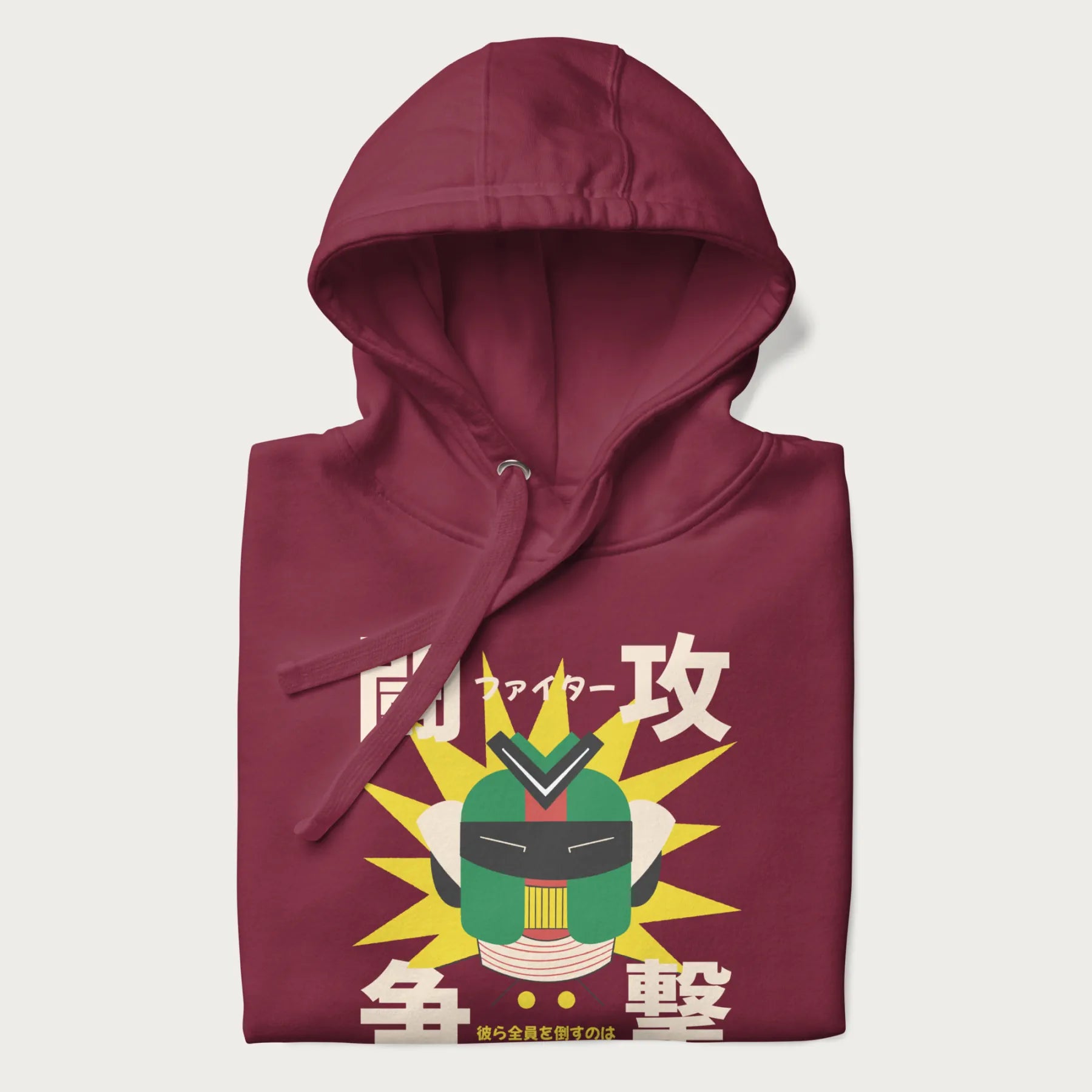 Folded maroon hoodie with retro graphic of a mecha warrior and Japanese text for "Fight," "Attack," "Conflict," and "Destiny to defeat them all".
