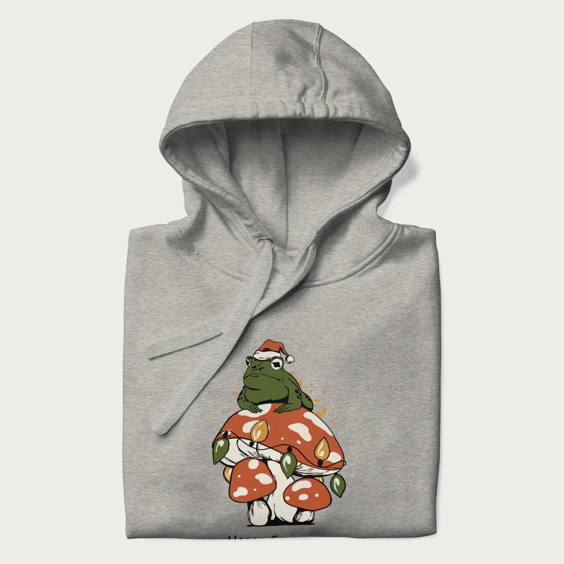 Folded light grey hoodie with graphic of a frog in a Santa hat on a mushroom with Christmas lights and the text 'Merry Christmas' below.