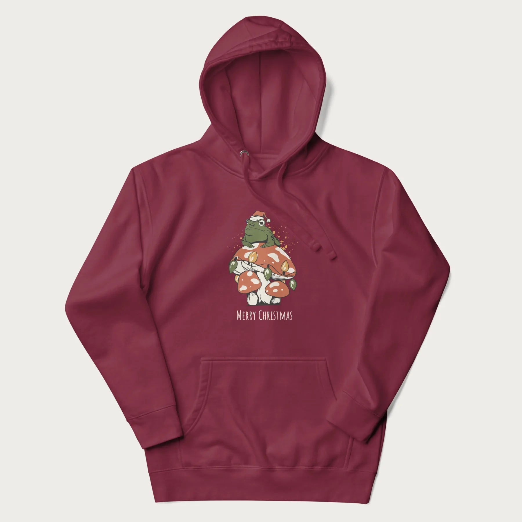 Maroon hoodie with graphic of a frog in a Santa hat on a mushroom with Christmas lights and the text 'Merry Christmas' below.