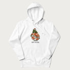 White hoodie with graphic of a frog in a Santa hat on a mushroom with Christmas lights and the text 'Merry Christmas' below.