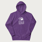 Purple hoodie with a graphic of a white cat holding a knife over a dog with a funny phrase 'Umm, He Slipped'.