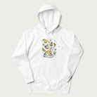 White hoodie featuring a Cottagecore-themed graphic with oranges, a floral porcelain cup, orange pie, and daisies.