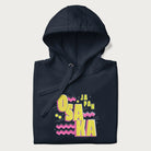 Folded navy blue hoodie featuring a colorful 'OSAKA JAPAN' pop art design in bold pink and yellow, with abstract geometric shapes.