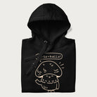 Folded black hoodie with graphic of a cute mushroom waving and the text "Porto-hello!"