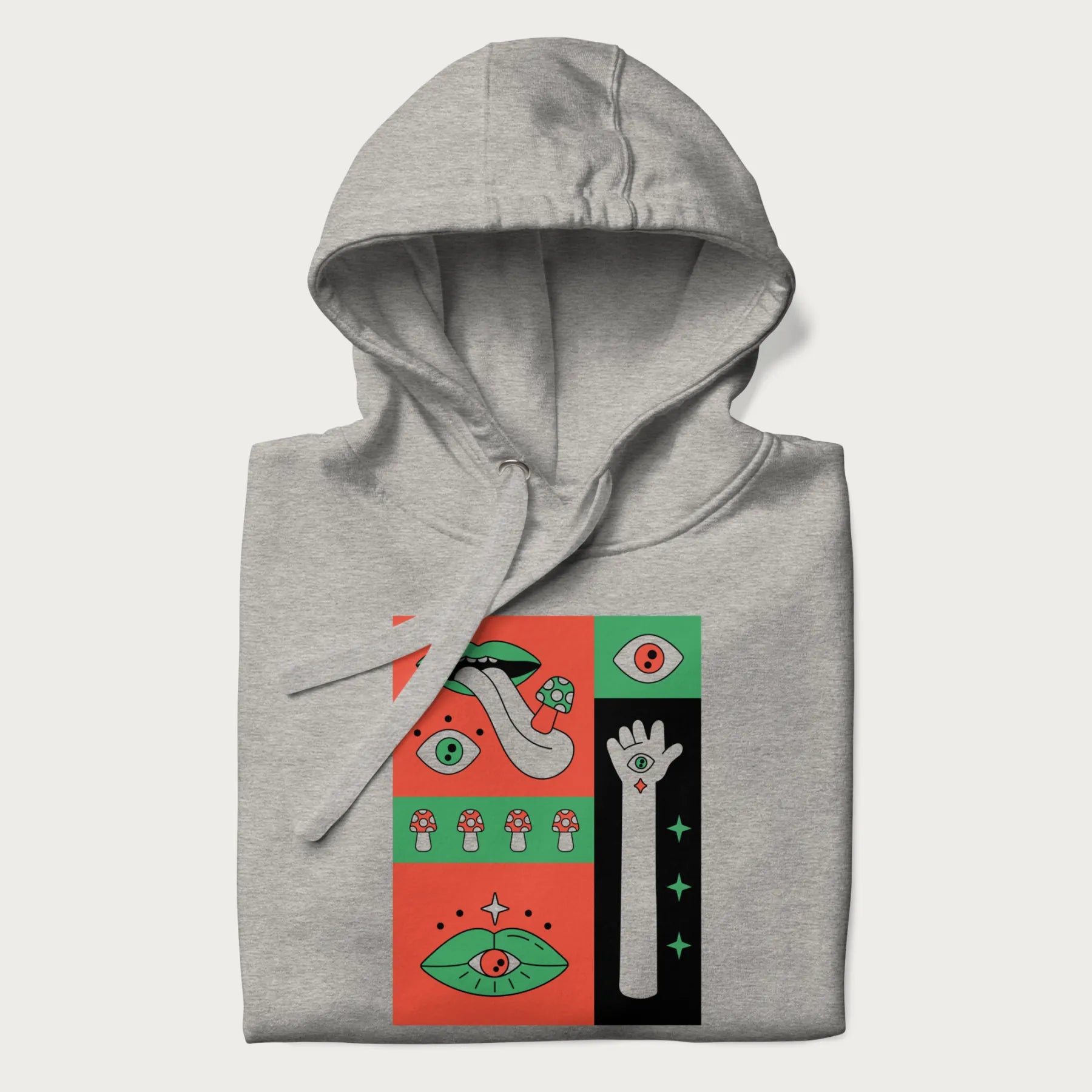 Folded light grey hoodie with mushroom psychedelic designs of surreal elements like lips, eyes, and mushrooms.