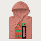 Folded light pink hoodie with mushroom psychedelic designs of surreal elements like lips, eyes, and mushrooms.