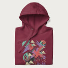 Folded maroon hoodie with Japanese crane graphic in vibrant colors and Japanese text '鶴' (Crane) and '高く飛ぶ' (Fly High).