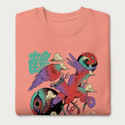 Folded light pink sweatshirt with a vibrant psychedelic Japanese crane graphic and Japanese text.