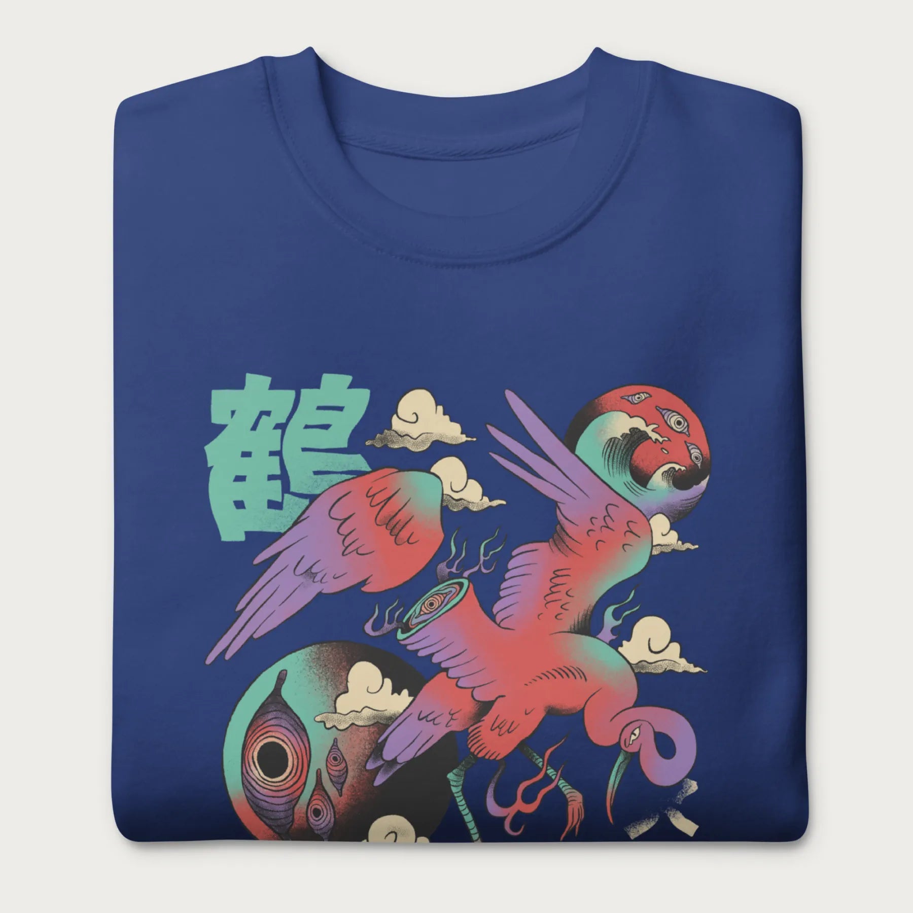 Folded royal blue sweatshirt with a vibrant psychedelic Japanese crane graphic and Japanese text.