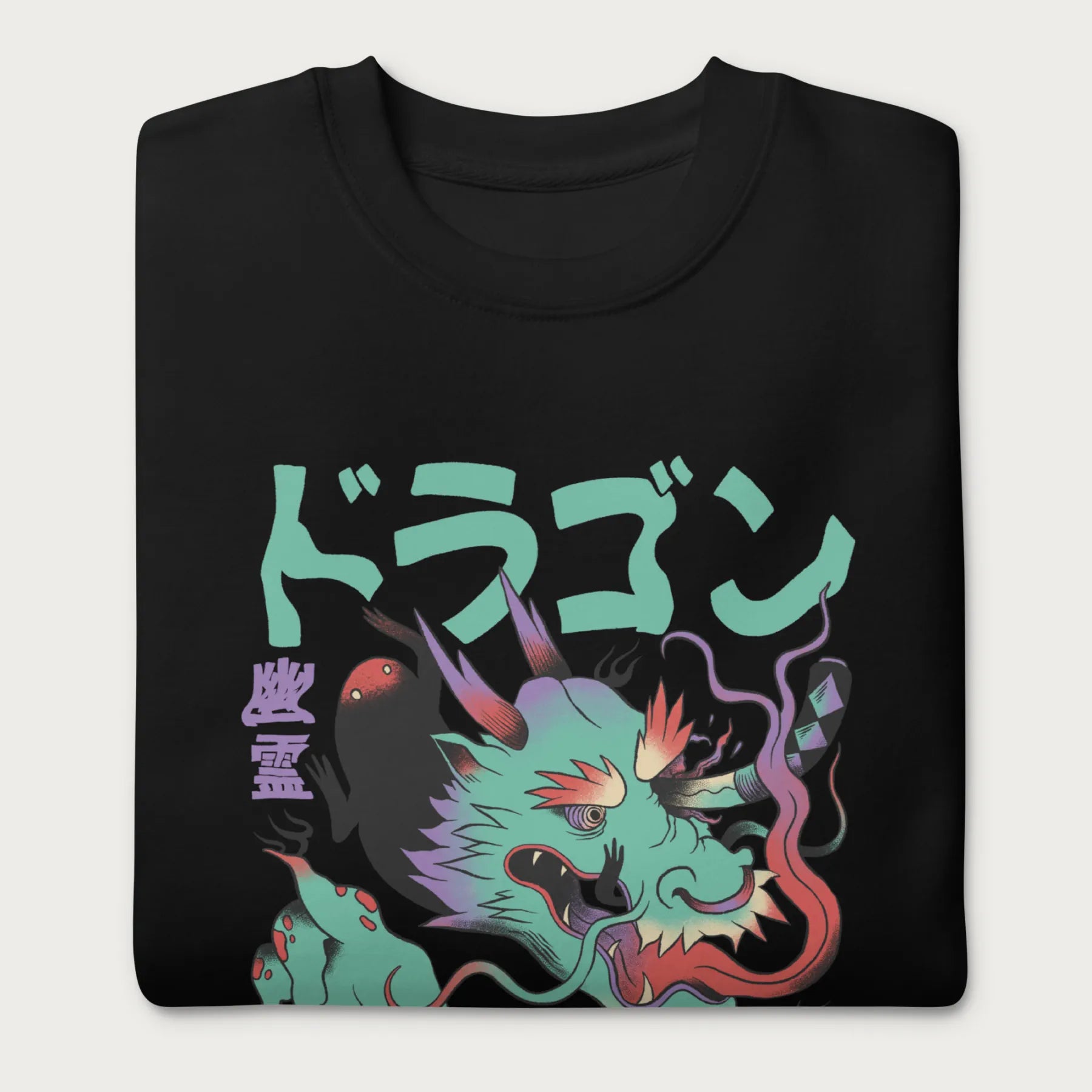 Folded black sweatshirt with a Japanese dragon graphic featuring vibrant colors and Japanese text.