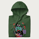 Folded forest green hoodie with Japanese psychedelic graphic of a frog with text '蛙' (Frog) and '幽靈' (Ghost) in Japanese characters.