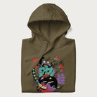 Folded military green hoodie with Japanese psychedelic graphic of a frog with text '蛙' (Frog) and '幽靈' (Ghost) in Japanese characters.