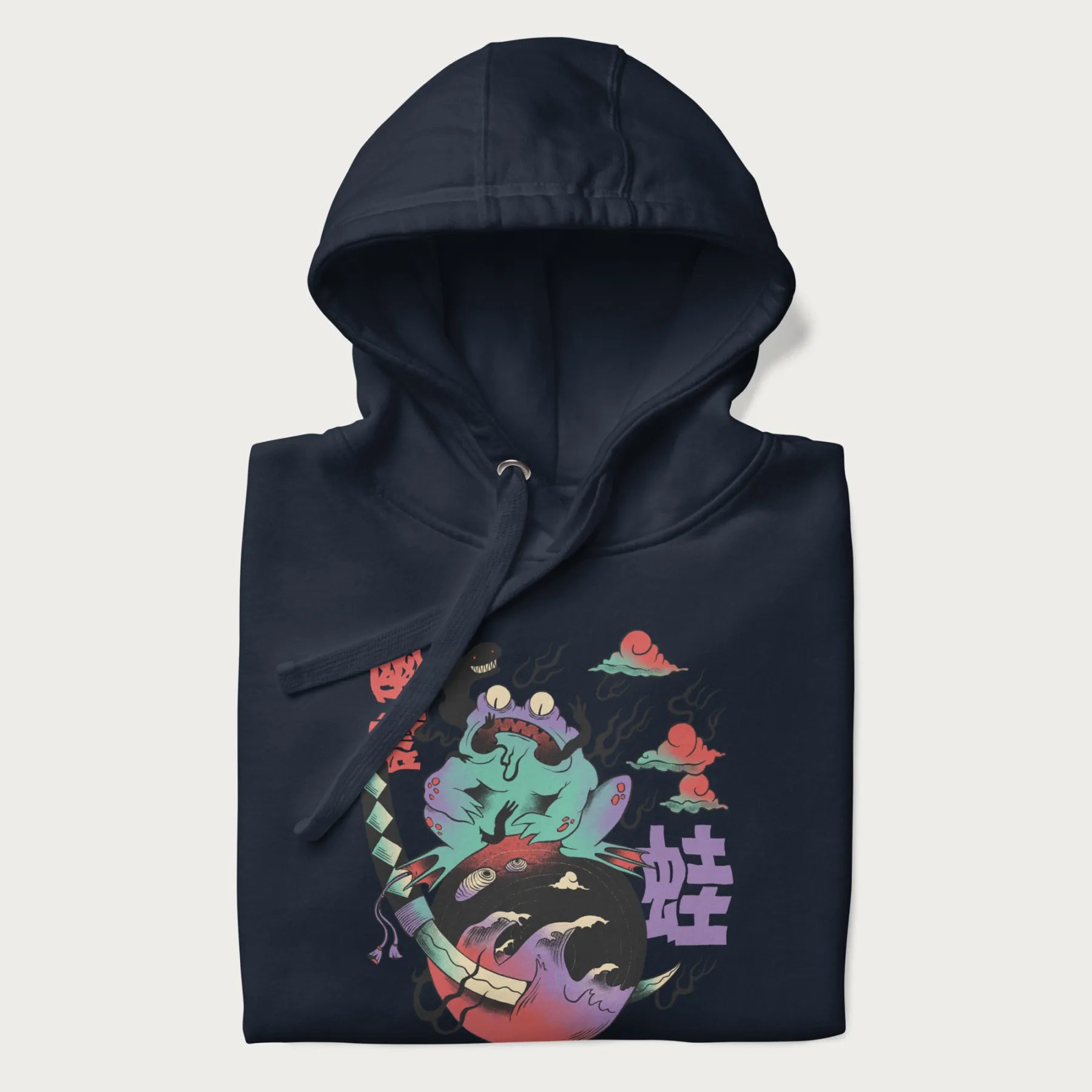 Folded navy blue hoodie with Japanese psychedelic graphic of a frog with text '蛙' (Frog) and '幽靈' (Ghost) in Japanese characters.