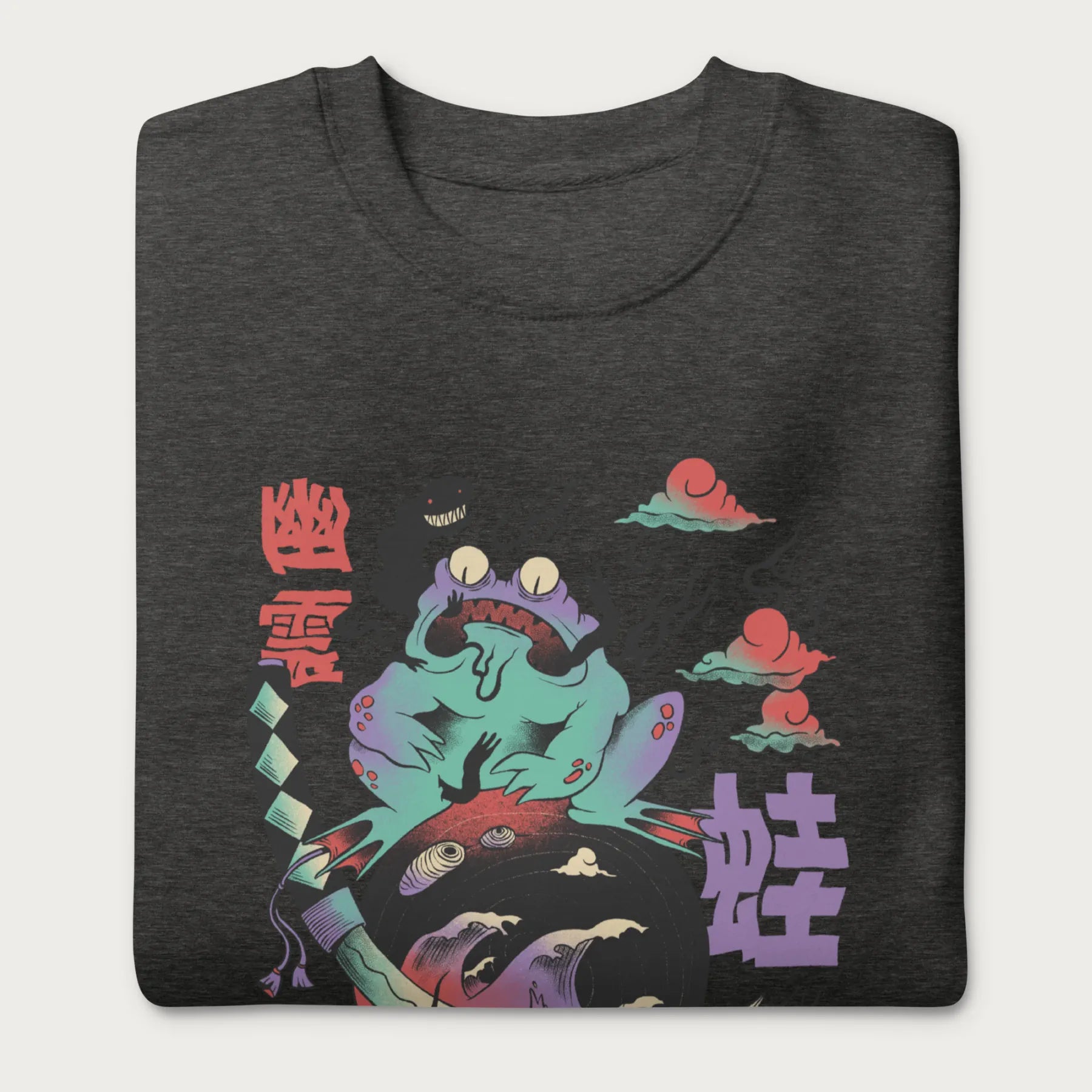 Folded dark grey sweatshirt with a psychedelic Japanese frog graphic in vibrant colors with Japanese text.