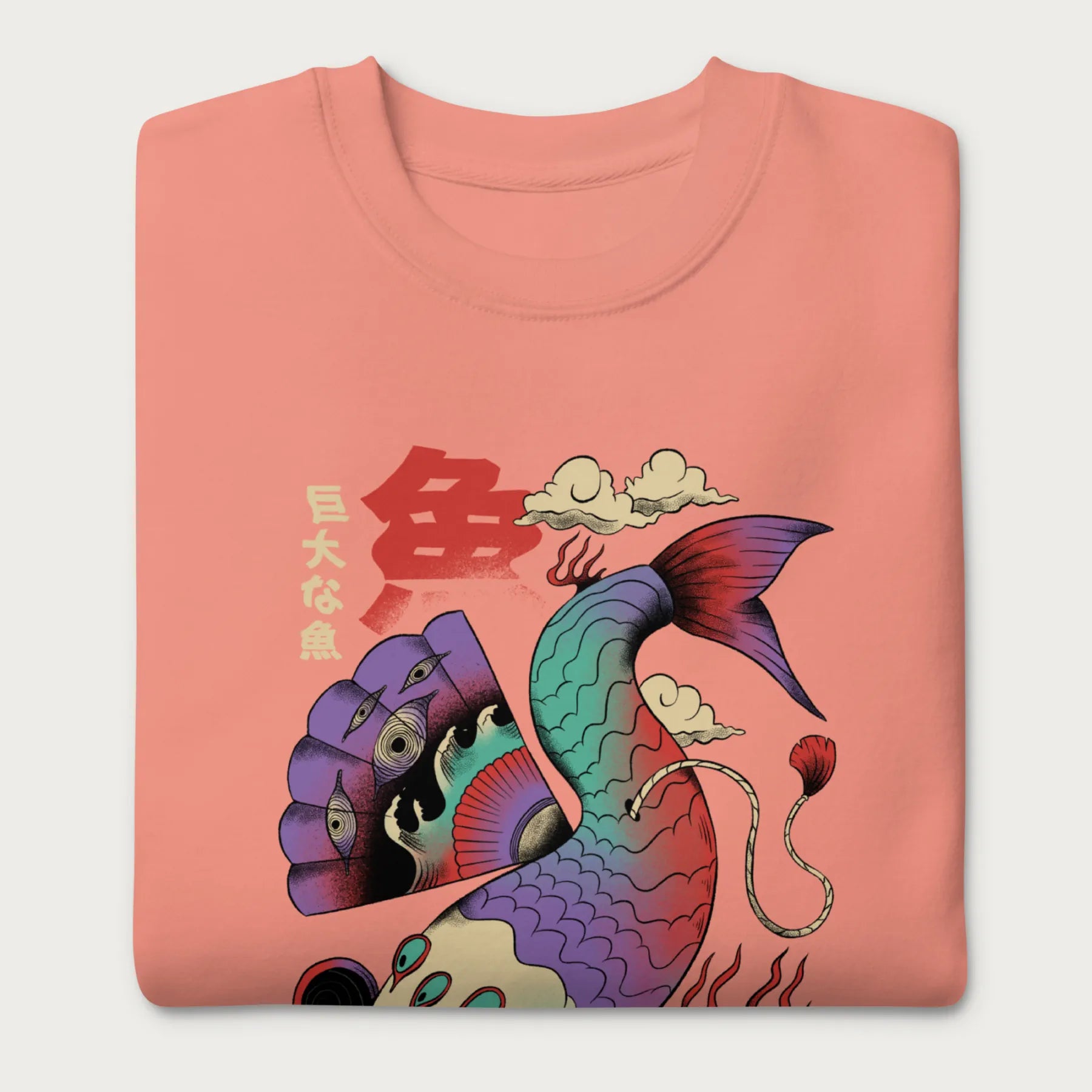 Folded light pink sweatshirt with a vibrant psychedelic Japanese koi fish graphic featuring intricate details and Japanese text.