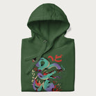 Folded forest green hoodie with Japanese psychedelic snake graphic, with Japanese text 'ヘビ' (Snake) and 'トリッピー' (Trippy) in vibrant colors.