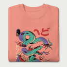 Folded light pink sweatshirt with a vibrant psychedelic Japanese snake graphic with Japanese text.