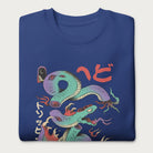 Folded royal blue sweatshirt with a vibrant psychedelic Japanese snake graphic with Japanese text.