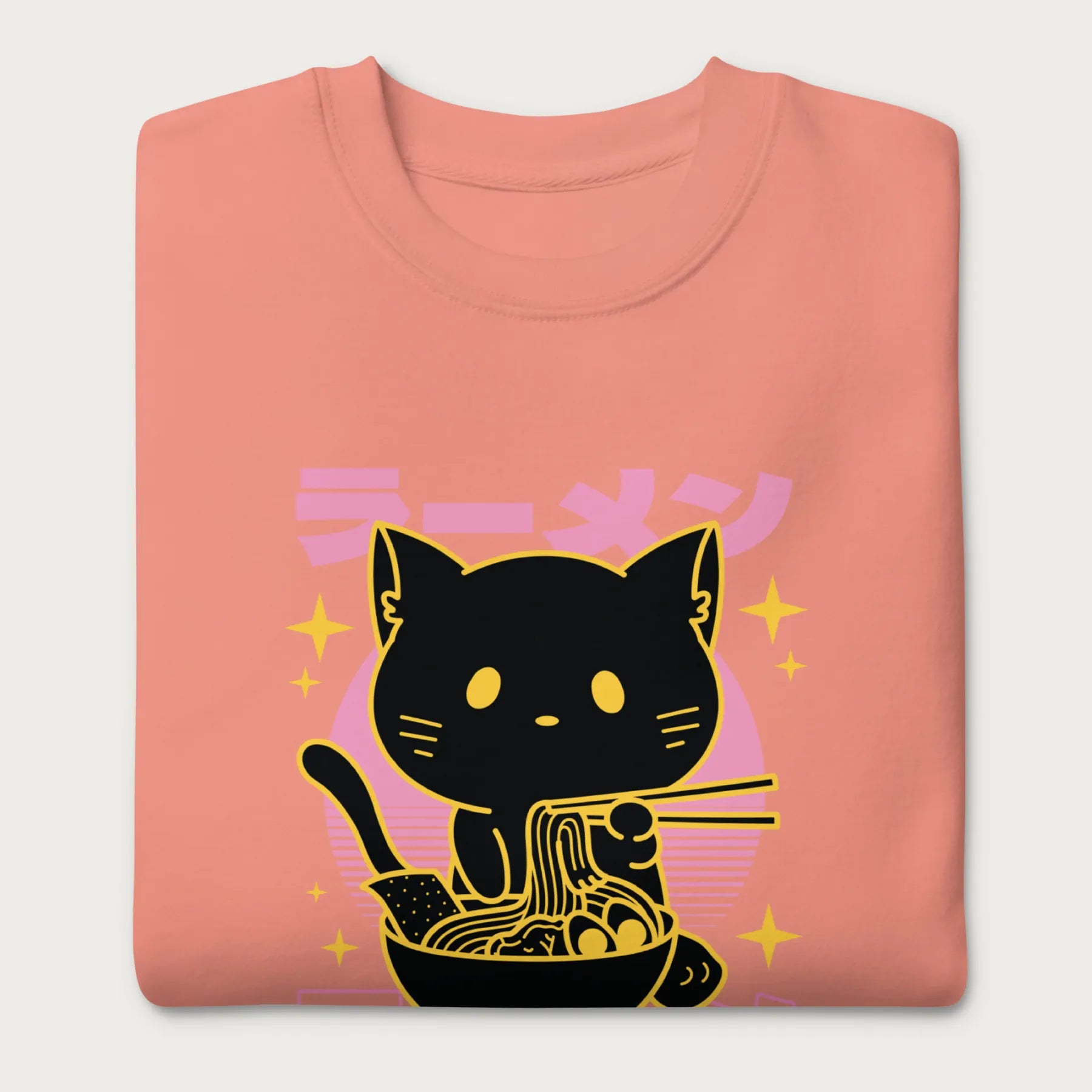 Folded light pink sweatshirt with Japanese text and a neon outline graphic of a cat eating ramen.