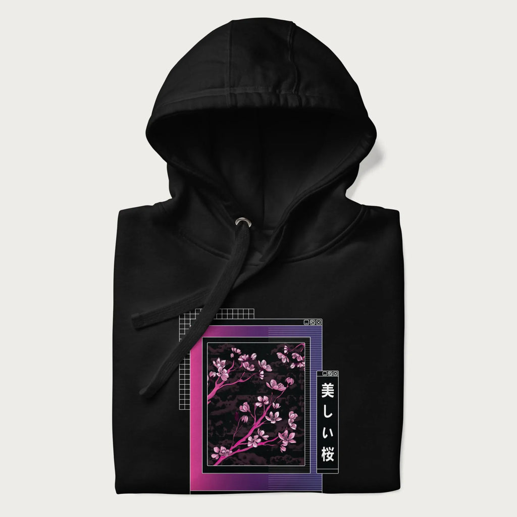 Folded black hoodie with vaporwave-style Japanese cherry blossom graphic.