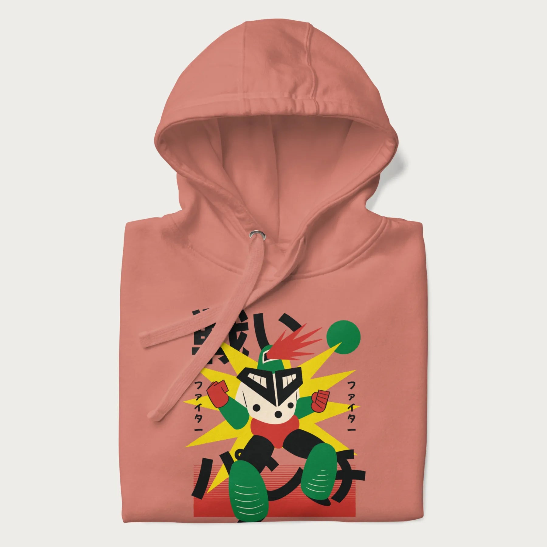 Folded light pink hoodie with Japanese text and a retro-futuristic robot fighter graphic.