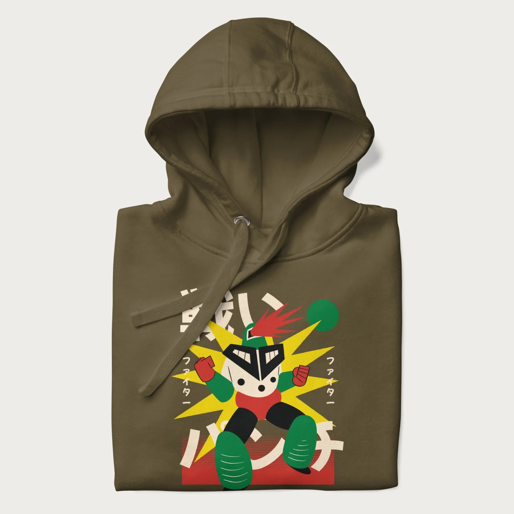 Folded military green hoodie with Japanese text and a retro-futuristic robot fighter graphic.