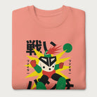 Folded light pink sweatshirt with Japanese text and a retro-styled robot graphic.