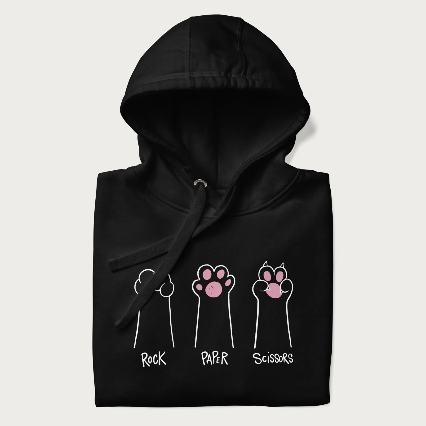 Folded black hoodie with graphic of cat paws playing rock-paper-scissors.