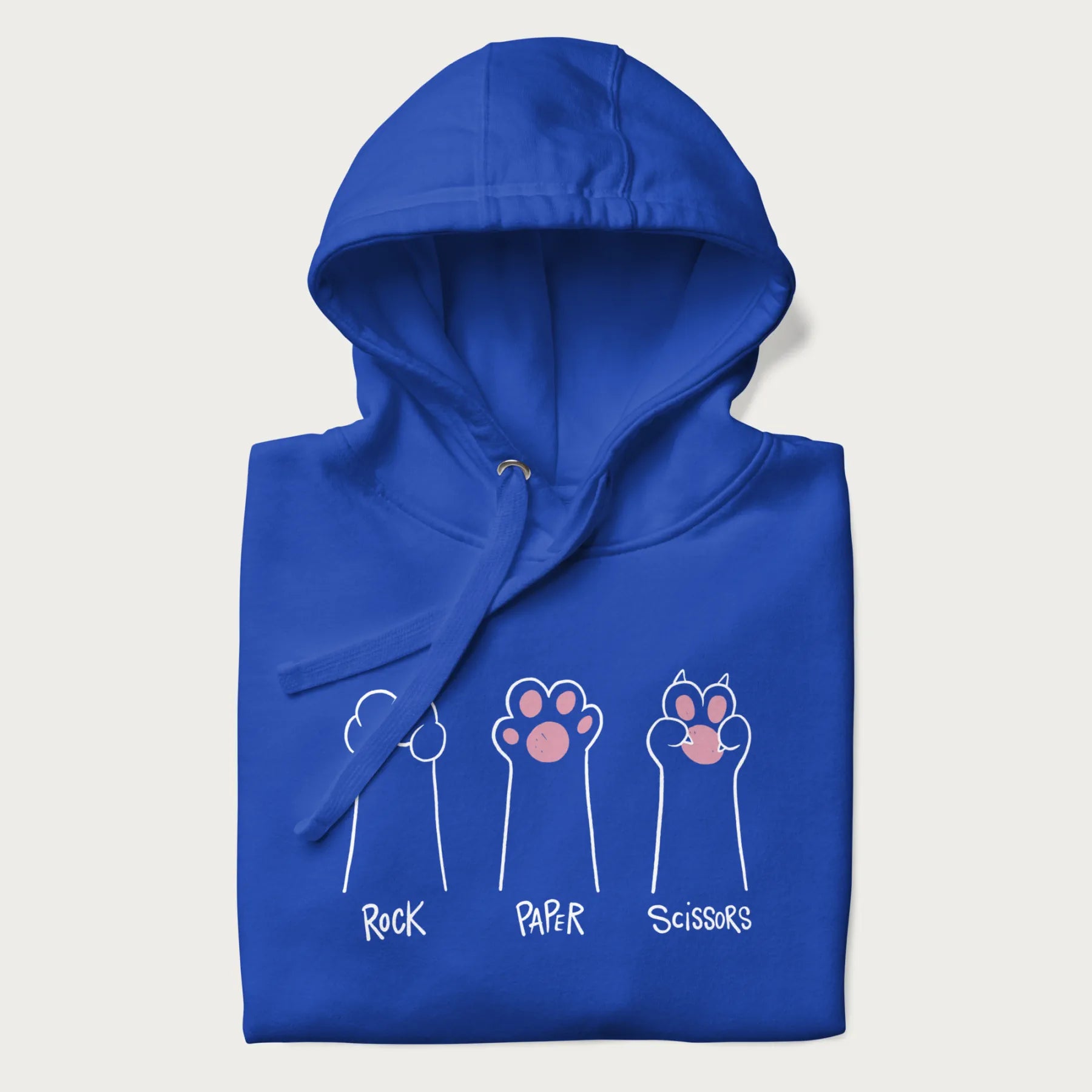 Folded royal blue hoodie with graphic of cat paws playing rock-paper-scissors.