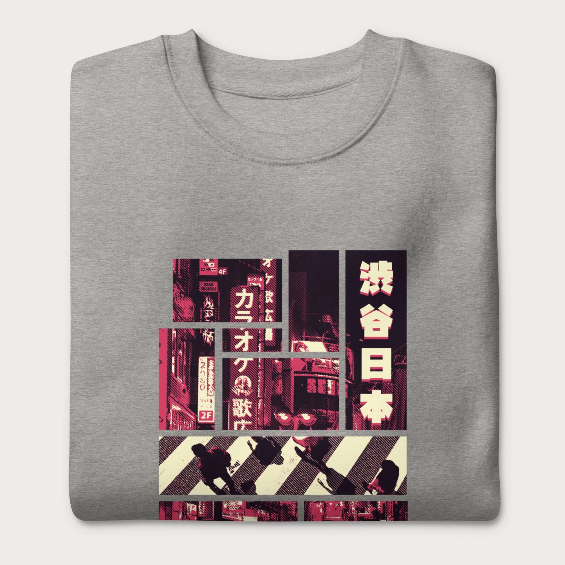 Folded light grey sweatshirt with a graphic panels of Shibuya's nightlife, featuring the iconic crosswalk, neon signs, and Japanese text.