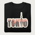 Folded black sweatshirt with a graphic of Tokyo's skyline integrated within the letters spelling "TOKYO."