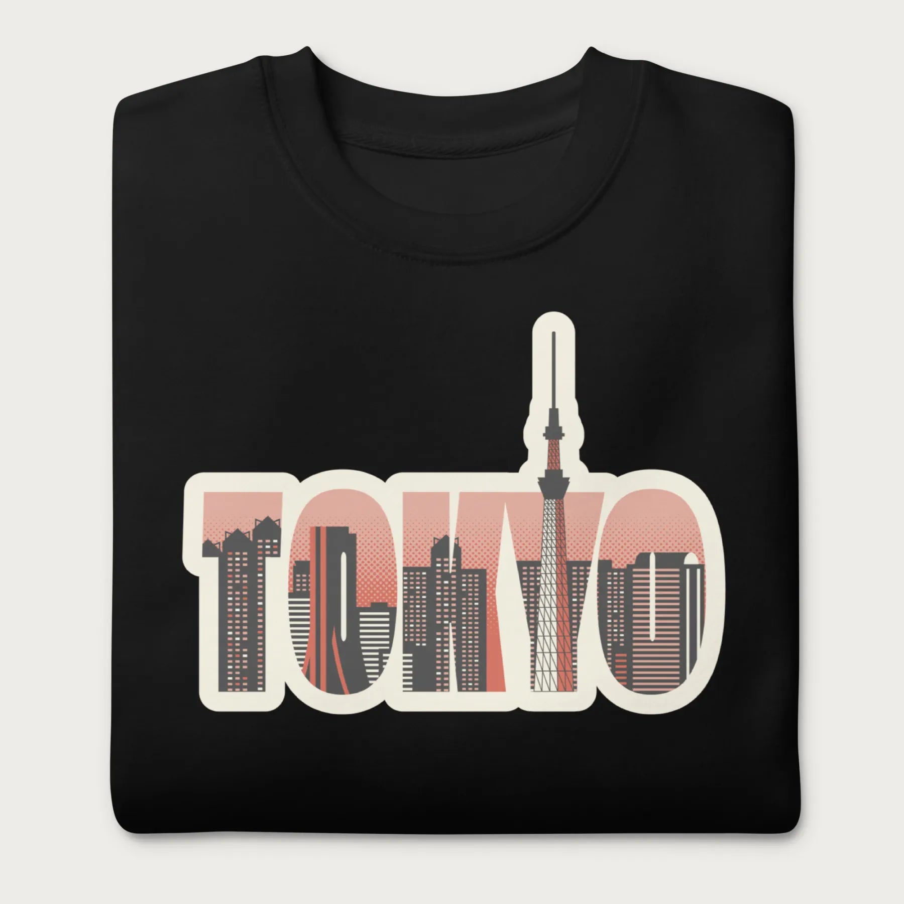 Folded black sweatshirt with a graphic of Tokyo's skyline integrated within the letters spelling "TOKYO."