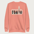 Light pink sweatshirt with a graphic of Tokyo's skyline integrated within the letters spelling "TOKYO."