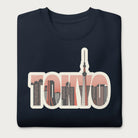 Folded navy blue sweatshirt with a graphic of Tokyo's skyline integrated within the letters spelling "TOKYO."