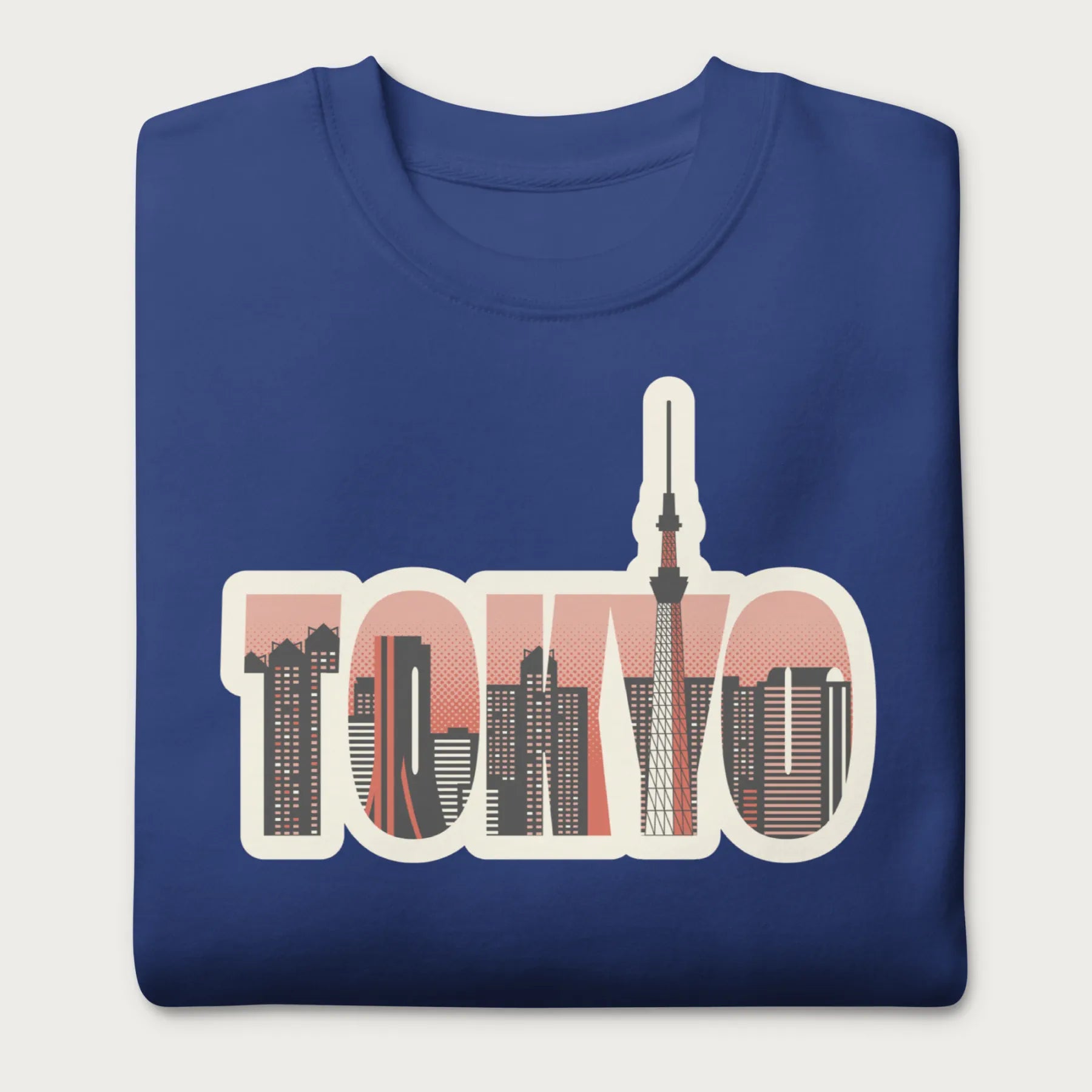 Folded royal blue sweatshirt with a graphic of Tokyo's skyline integrated within the letters spelling "TOKYO."