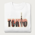 Folded white sweatshirt with a graphic of Tokyo's skyline integrated within the letters spelling "TOKYO."