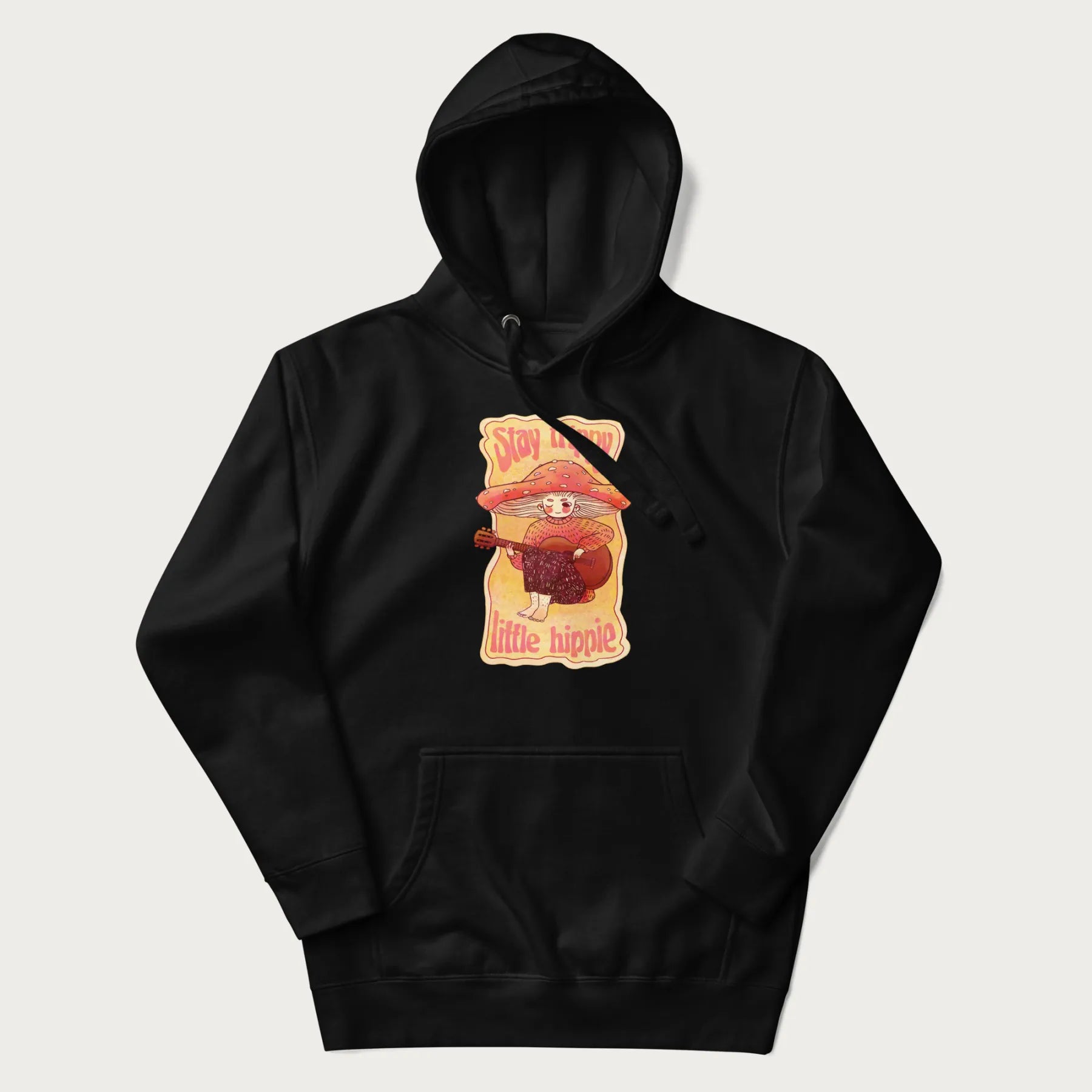Black hoodie with a graphic of a character with a mushroom cap playing a guitar and the text 'Stay Trippy Little Hippie.'