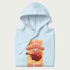Folded light blue hoodie with a graphic of a character with a mushroom cap playing a guitar and the text 'Stay Trippy Little Hippie.'