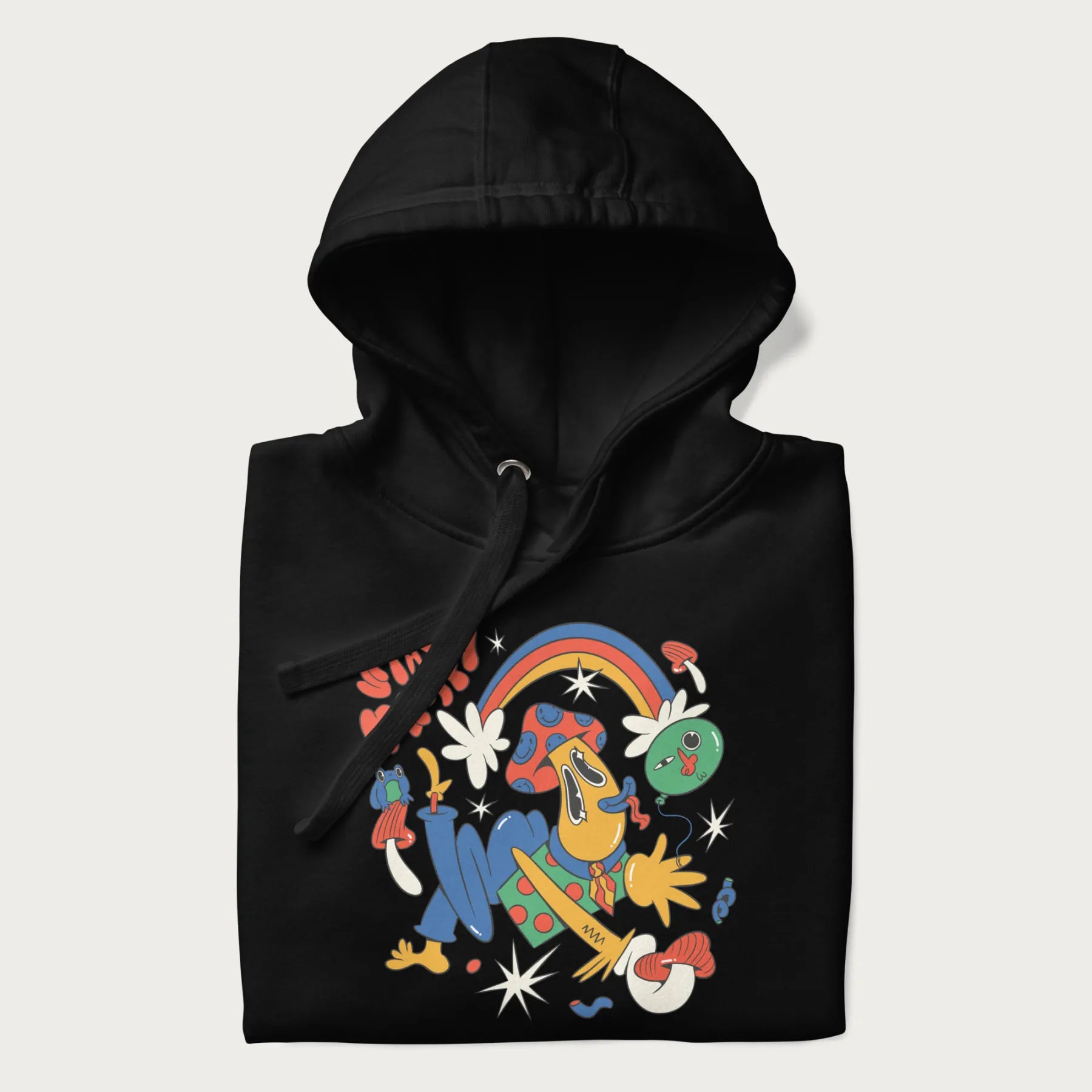 Folded black trippy hoodie featuring a colorful psychedelic design with playful characters and the text "Stay Trippy".