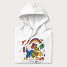 Folded white trippy hoodie featuring a colorful psychedelic design with playful characters and the text "Stay Trippy".