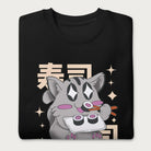 Folded black sweatshirt with Japanese text and a kawaii graphic of a cat eating sushi.